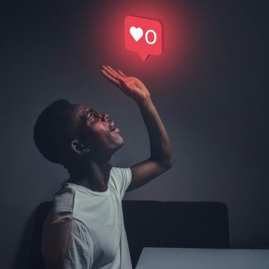 There is a man looking up and there is a social media notification heart with the 0 number floating to express the end.